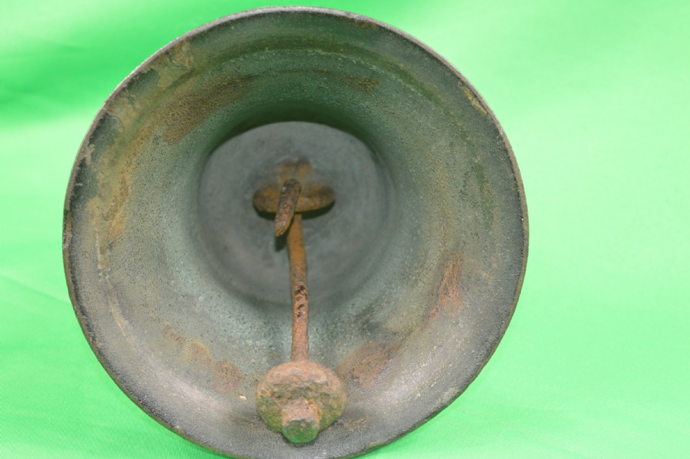 A nineteenth-century cast bronze ships bell featuring a dark aged patina, subtle molded body ring detailing, and an upper mounting lug. View V
