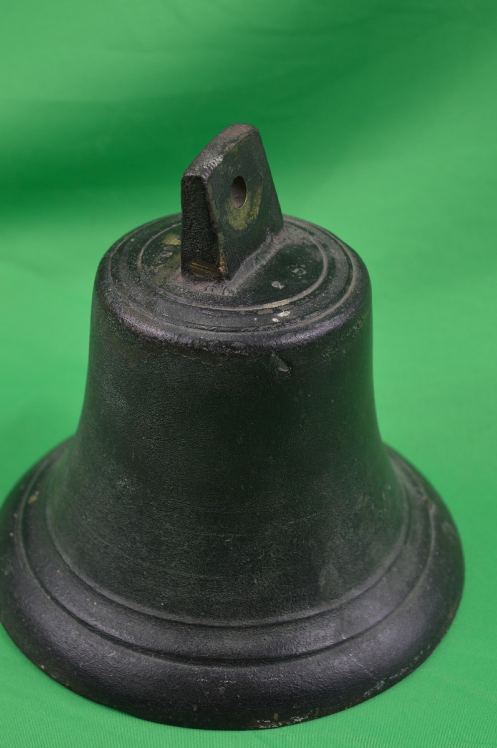 A nineteenth-century cast bronze ships bell featuring a dark aged patina, subtle molded body ring detailing, and an upper mounting lug. View VI