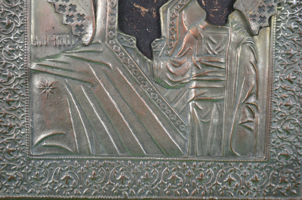 A late nineteenth-century Russian Orthodox icon depicting the Virgin Mary and Child beneath a chased metal oklad cover. View V