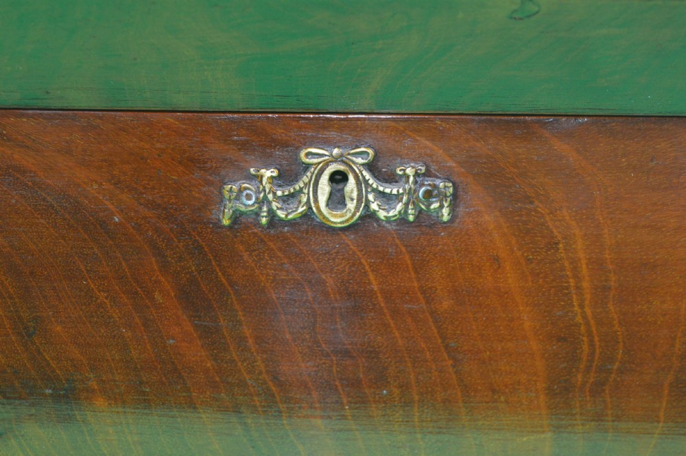 A Regency mahogany tea caddy featuring a tapered sarcophagus shape, stepped hinged lid, and central brass keyhole escutcheon. View II