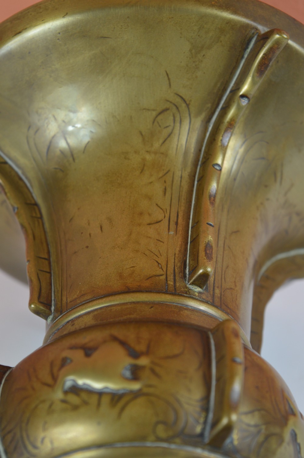 A cast bronze trumpet-shaped Chinese Gu vase with vertical flanges, a bulbous central section, and incised archaic pattern detailing. View VIII
