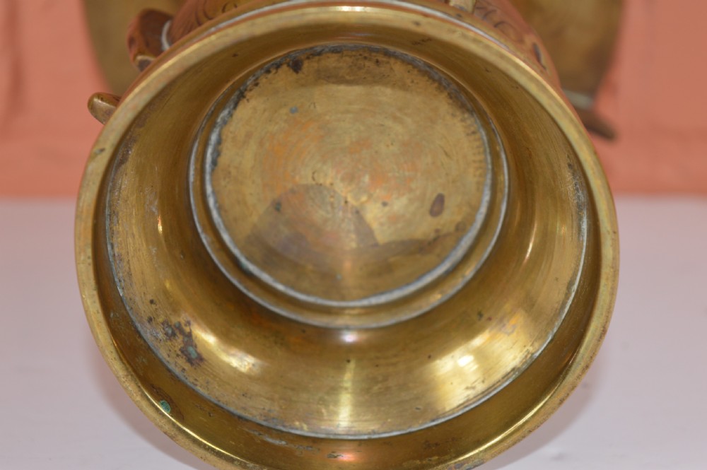 A cast bronze trumpet-shaped Chinese Gu vase with vertical flanges, a bulbous central section, and incised archaic pattern detailing. View IX