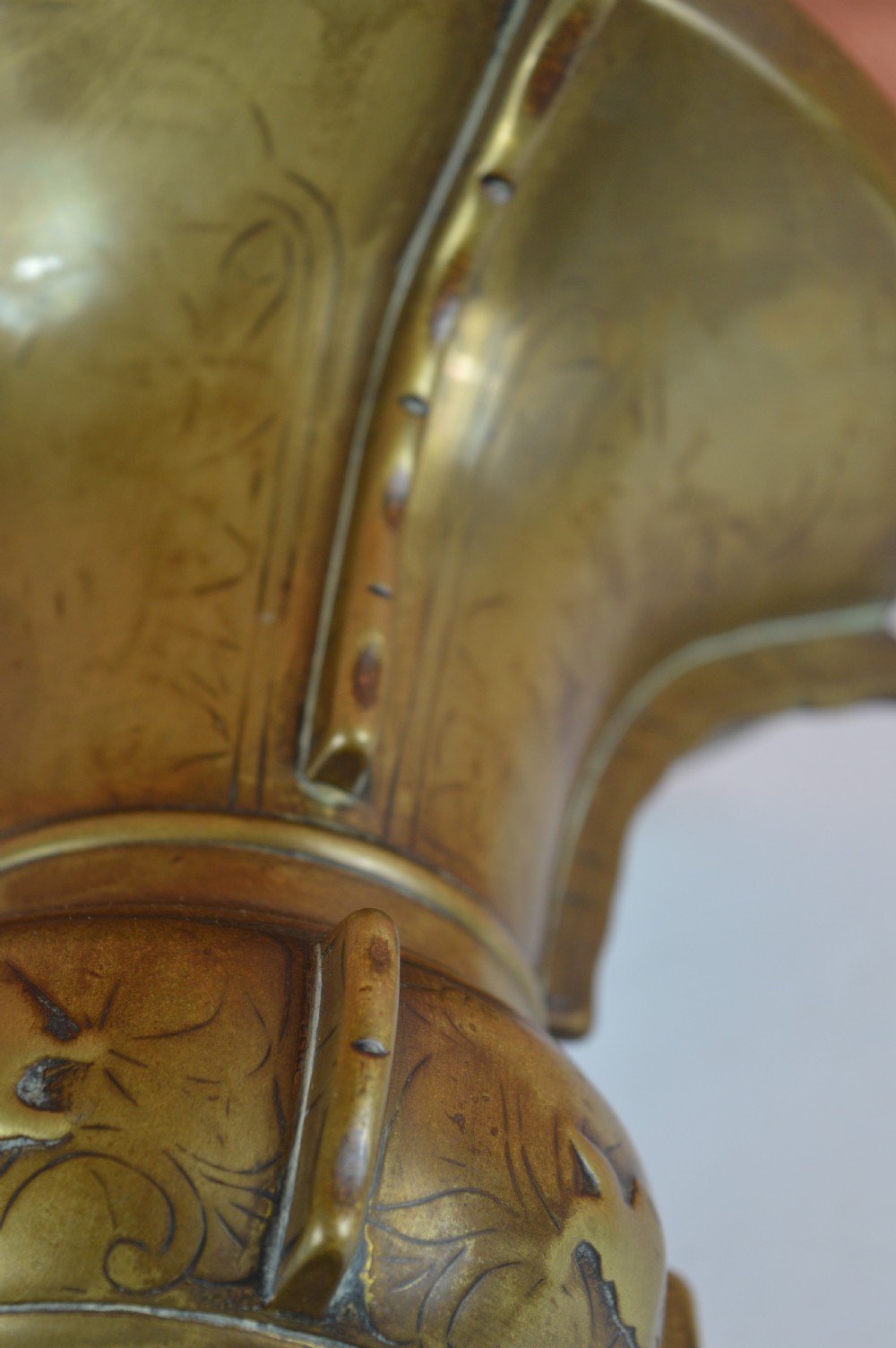 A cast bronze trumpet-shaped Chinese Gu vase with vertical flanges, a bulbous central section, and incised archaic pattern detailing. View X
