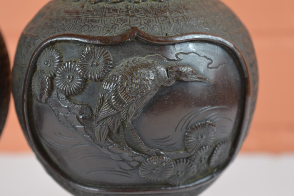A pair of dark brown patinated Japanese bronze vases featuring dragon-form handles and relief panels depicting birds amongst aquatic foliage. View VIII