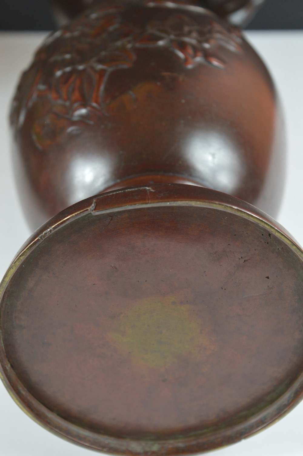 A cast dark bronze baluster vase featuring dragon-form side handles, a flared rim, and relief carvings of birds perched on flowering branches. View IX