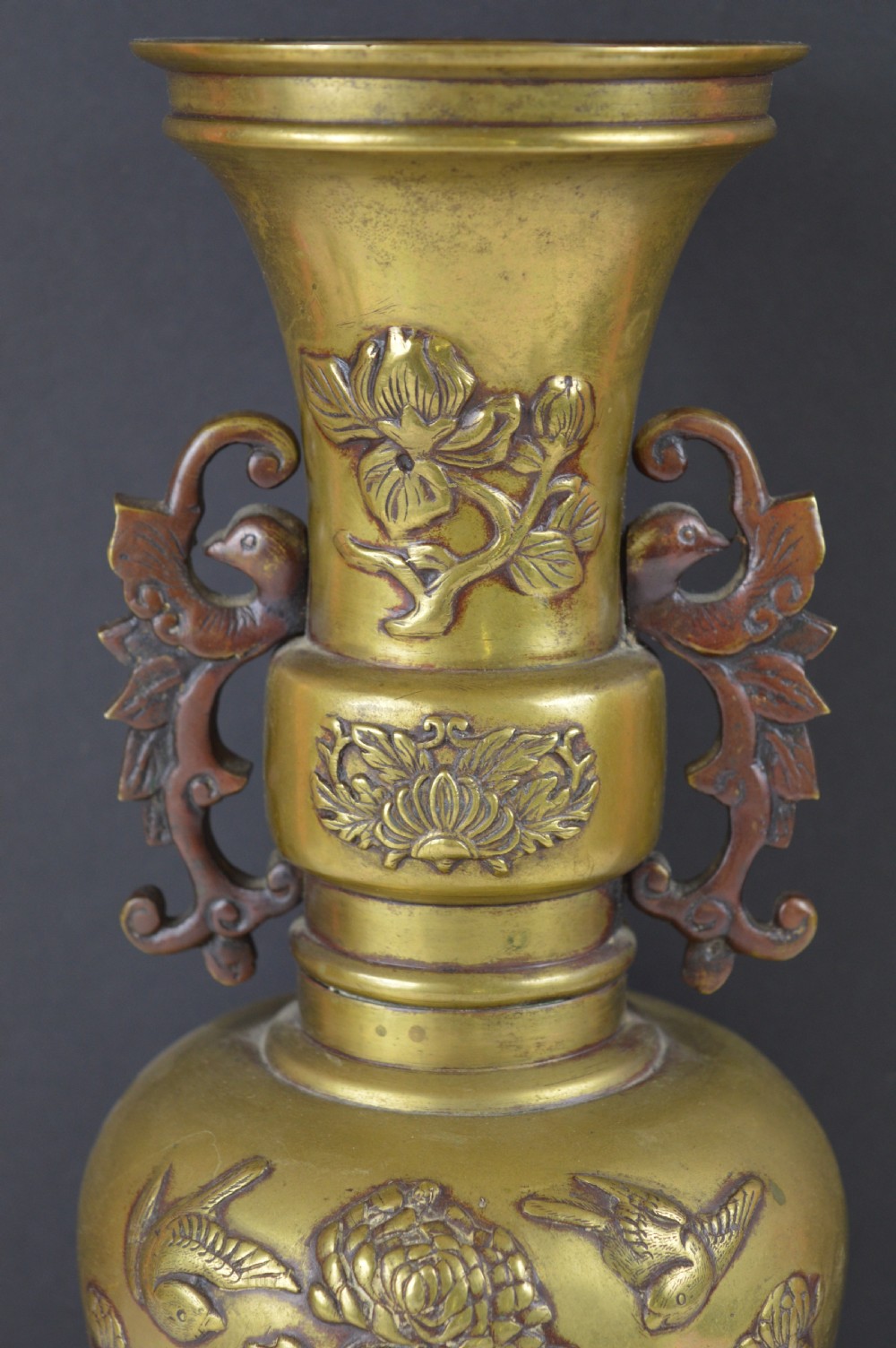 A cast bronze baluster vase featuring relief depictions of birds and flowers with bird-shaped side handles. View II