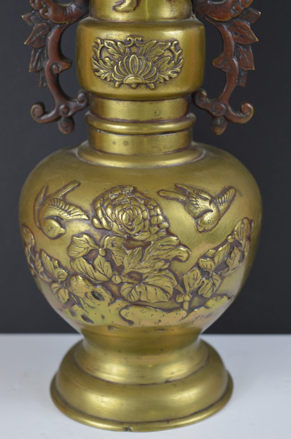 A cast bronze baluster vase featuring relief depictions of birds and flowers with bird-shaped side handles. View III