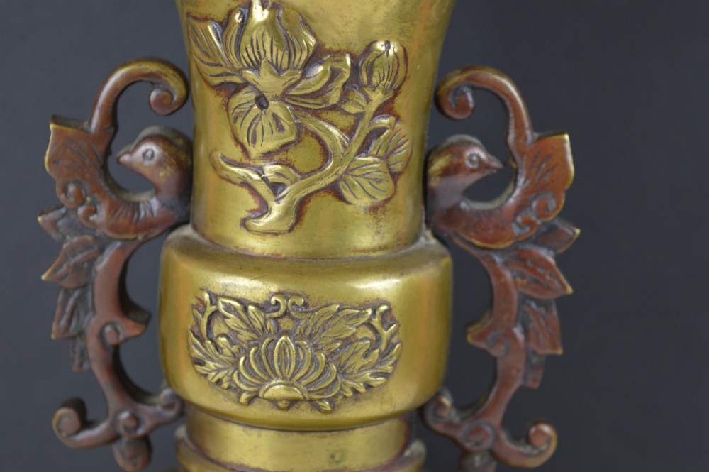 A cast bronze baluster vase featuring relief depictions of birds and flowers with bird-shaped side handles. View V