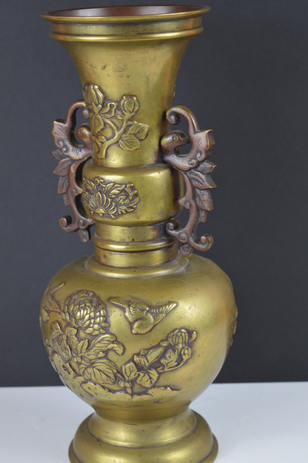 A cast bronze baluster vase featuring relief depictions of birds and flowers with bird-shaped side handles. View VI
