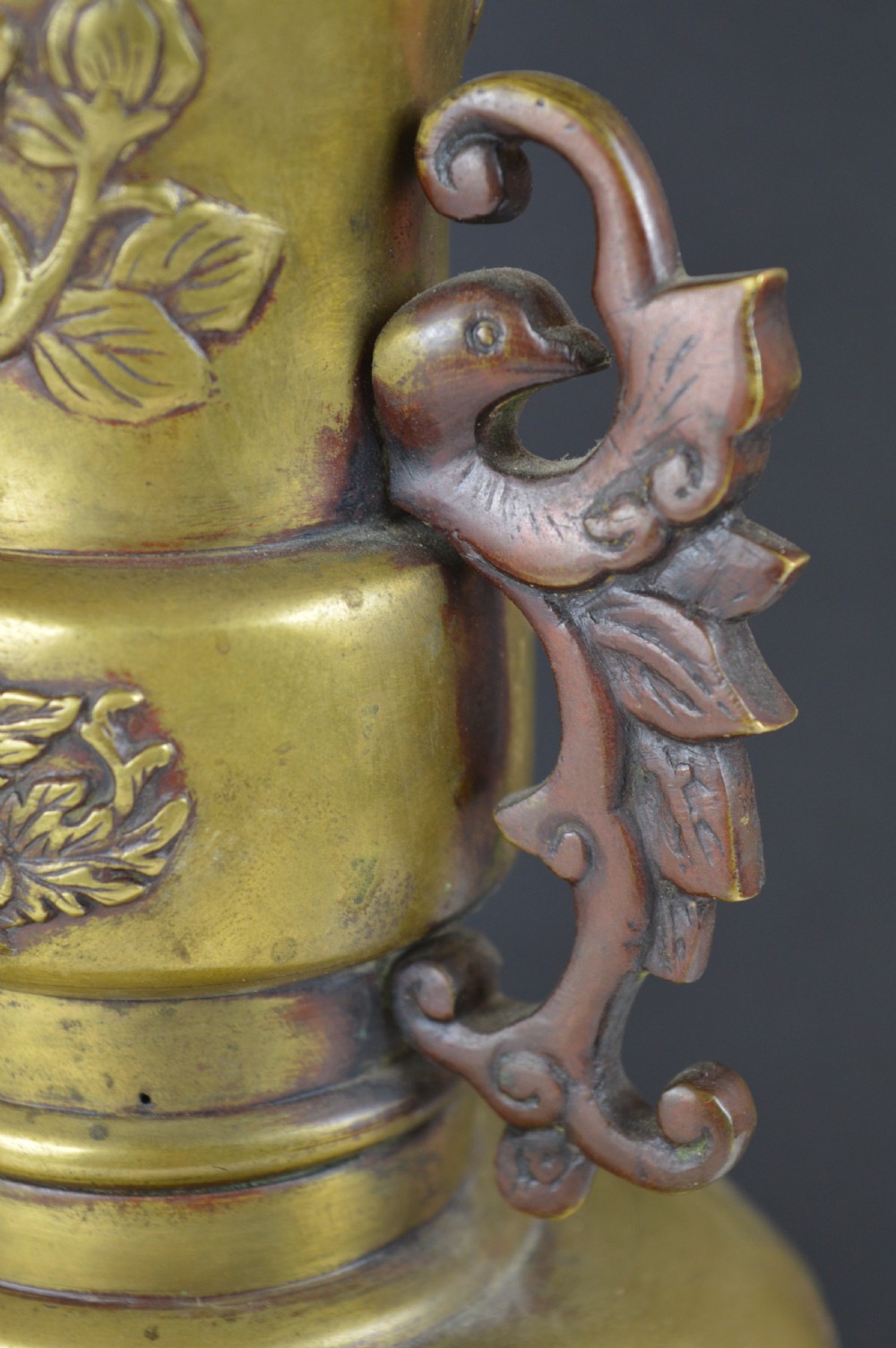 A cast bronze baluster vase featuring relief depictions of birds and flowers with bird-shaped side handles. View VII