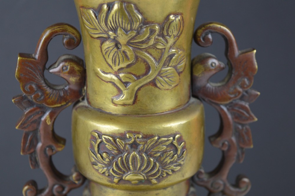 A cast bronze baluster vase featuring relief depictions of birds and flowers with bird-shaped side handles. View IX