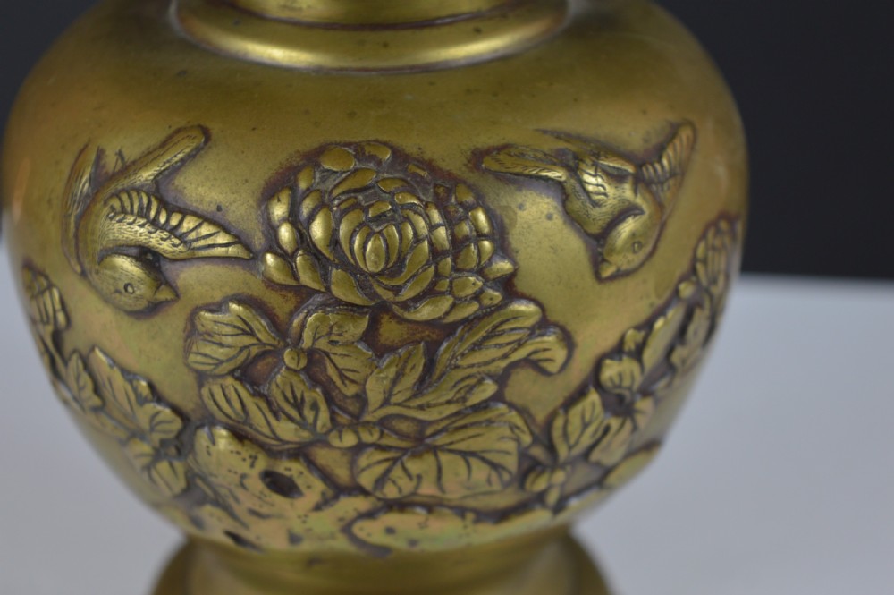 A cast bronze baluster vase featuring relief depictions of birds and flowers with bird-shaped side handles. View X