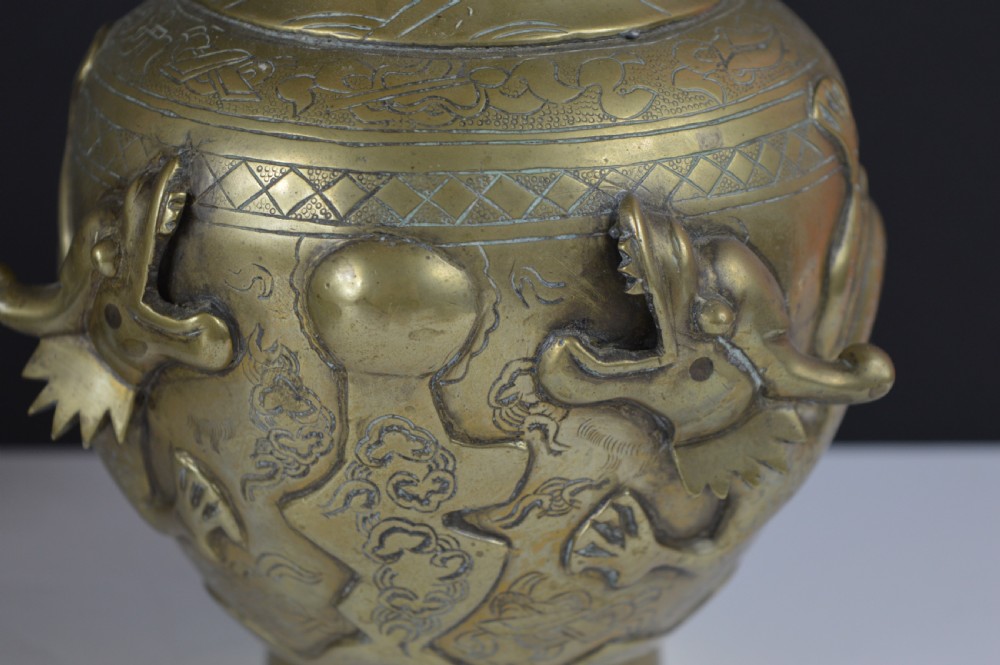 An antique brass baluster vase decorated with high-relief coiled dragons around the neck and body alongside engraved cloud patterns. View II