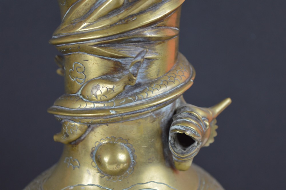 An antique brass baluster vase decorated with high-relief coiled dragons around the neck and body alongside engraved cloud patterns. View III