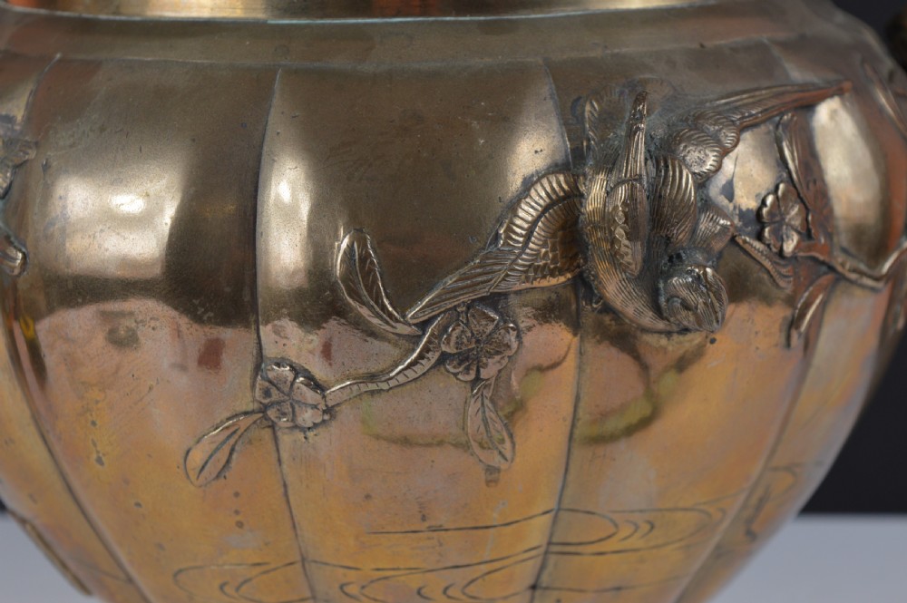 A heavy 19th-century Chinese bronze vessel featuring a lobed body adorned with raised relief carvings of birds and floral branches. View II