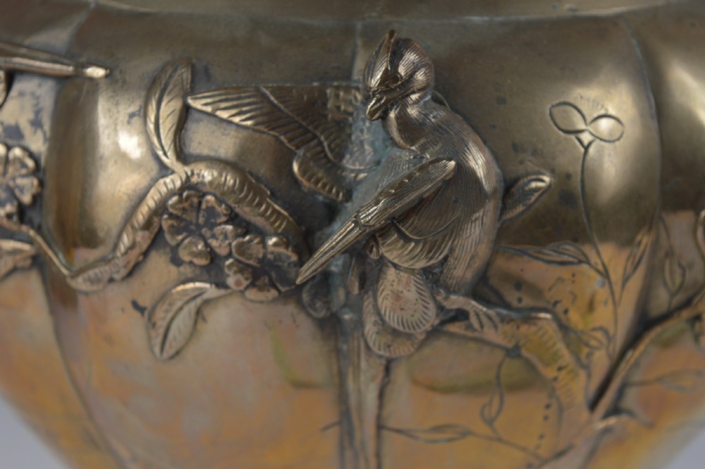 A heavy 19th-century Chinese bronze vessel featuring a lobed body adorned with raised relief carvings of birds and floral branches. View IV