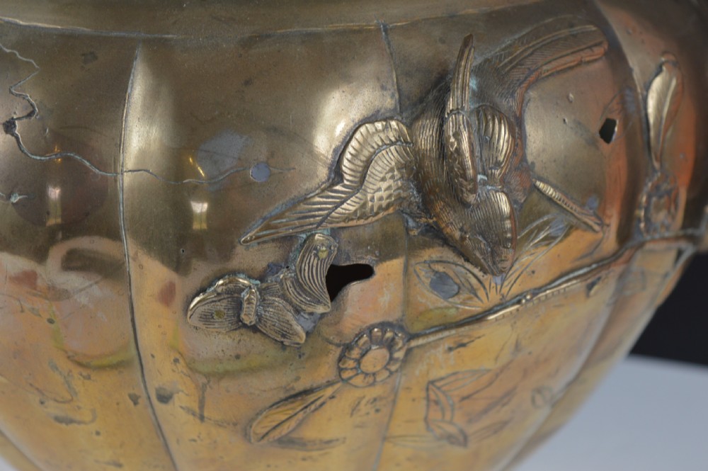 A heavy 19th-century Chinese bronze vessel featuring a lobed body adorned with raised relief carvings of birds and floral branches. View VI