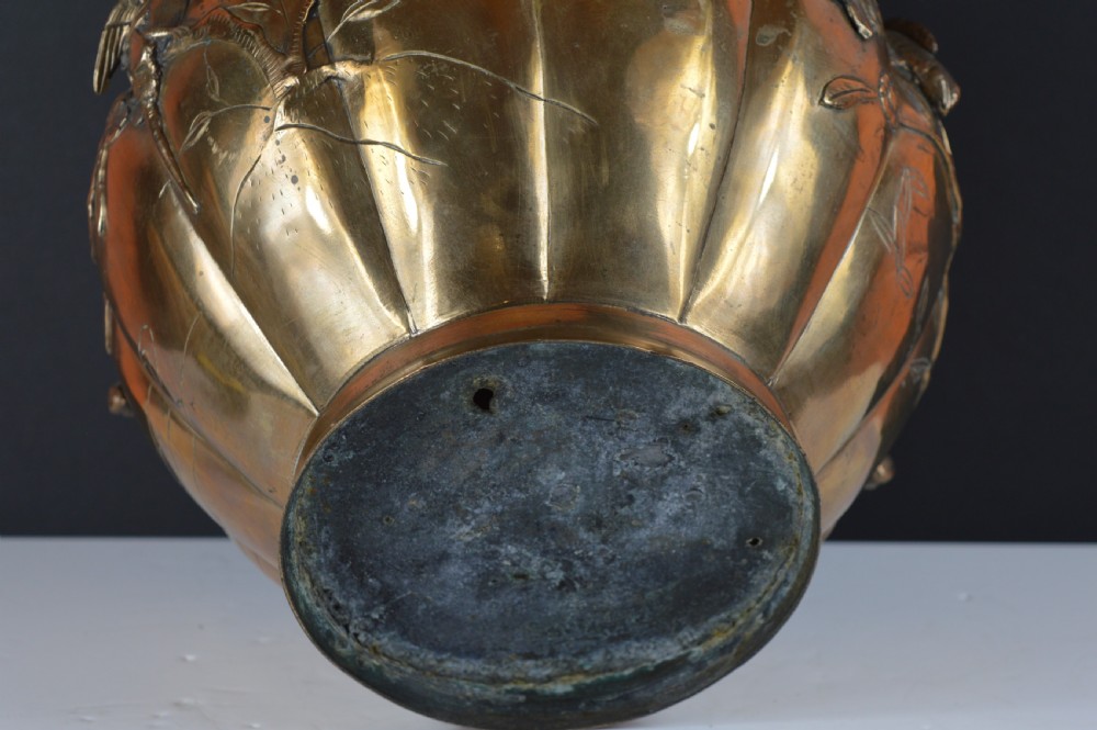 A heavy 19th-century Chinese bronze vessel featuring a lobed body adorned with raised relief carvings of birds and floral branches. View VII