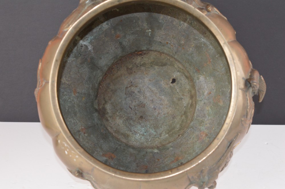 A heavy 19th-century Chinese bronze vessel featuring a lobed body adorned with raised relief carvings of birds and floral branches. View VIII