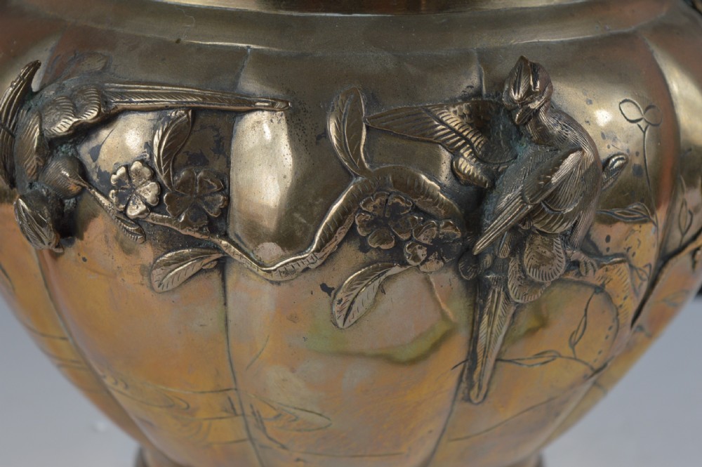 A heavy 19th-century Chinese bronze vessel featuring a lobed body adorned with raised relief carvings of birds and floral branches. View IX