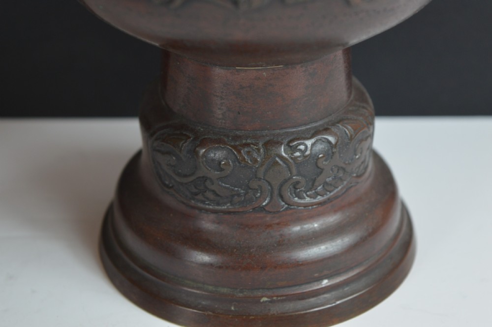 A dark brown patinated bronze vase with relief carvings of birds and flora, featuring flared rims and two stylized handles. View VII