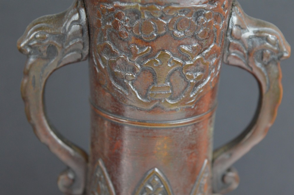 A dark brown patinated bronze vase with relief carvings of birds and flora, featuring flared rims and two stylized handles. View VIII