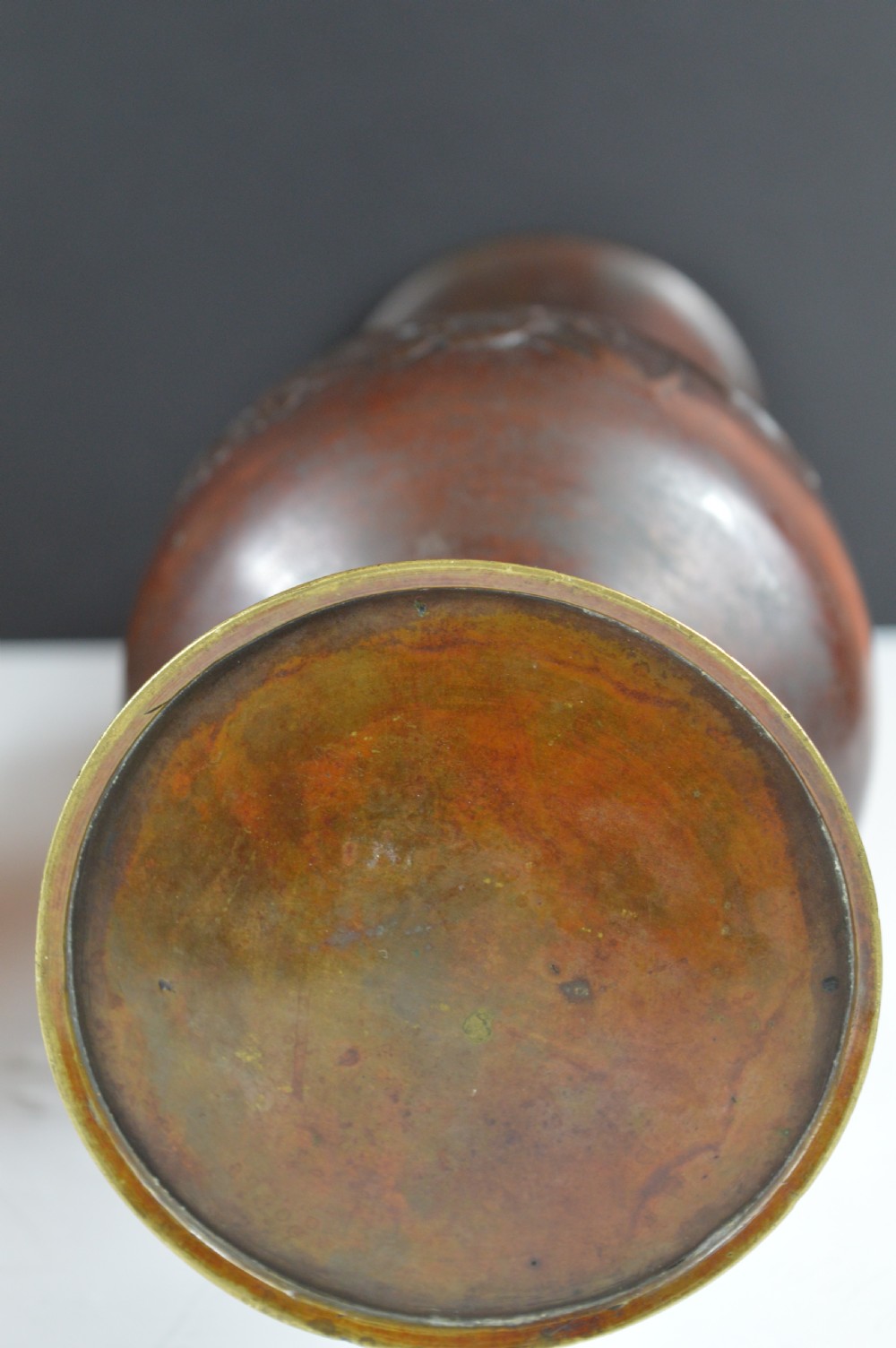 A dark brown patinated bronze vase with relief carvings of birds and flora, featuring flared rims and two stylized handles. View X