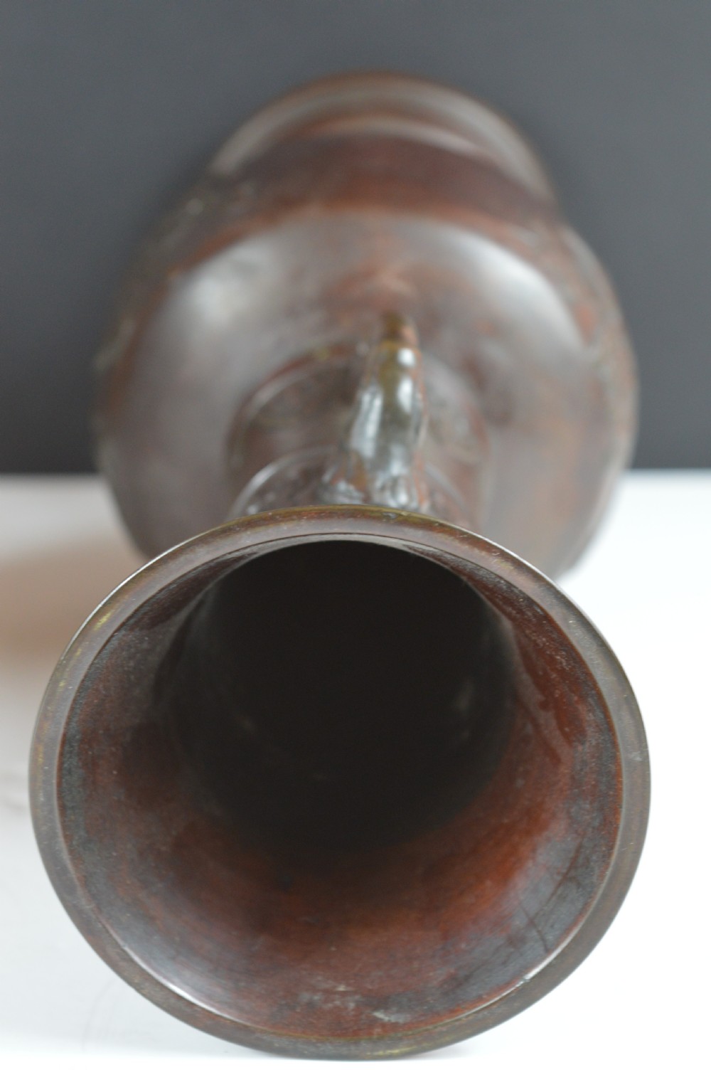 A dark brown patinated bronze vase with relief carvings of birds and flora, featuring flared rims and two stylized handles. View XI