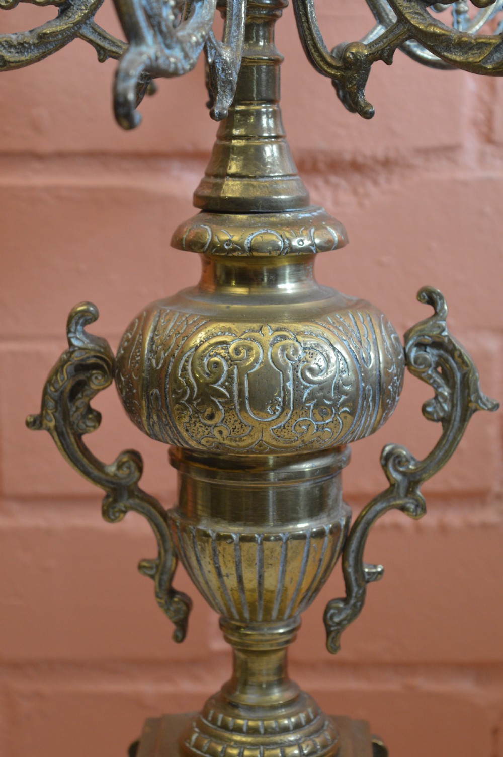 An ornate nineteenth-century French brass six-light candelabrum featuring elaborate scrollwork arms, an urn-shaped central column, and a cast footed base. View III