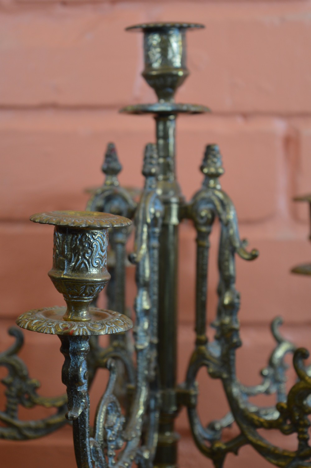 An ornate nineteenth-century French brass six-light candelabrum featuring elaborate scrollwork arms, an urn-shaped central column, and a cast footed base. View IV