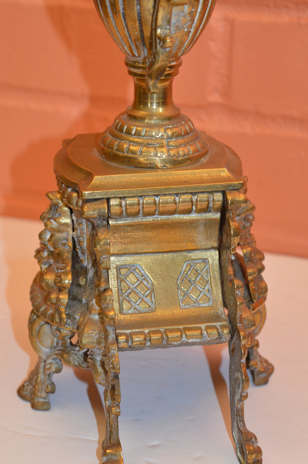 An ornate nineteenth-century French brass six-light candelabrum featuring elaborate scrollwork arms, an urn-shaped central column, and a cast footed base. View IX