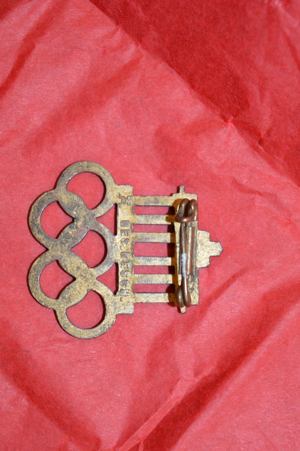 A 1936 Berlin Olympic Games enamel visitor badge featuring the Brandenburg Gate above five interconnected Olympic rings. View VI