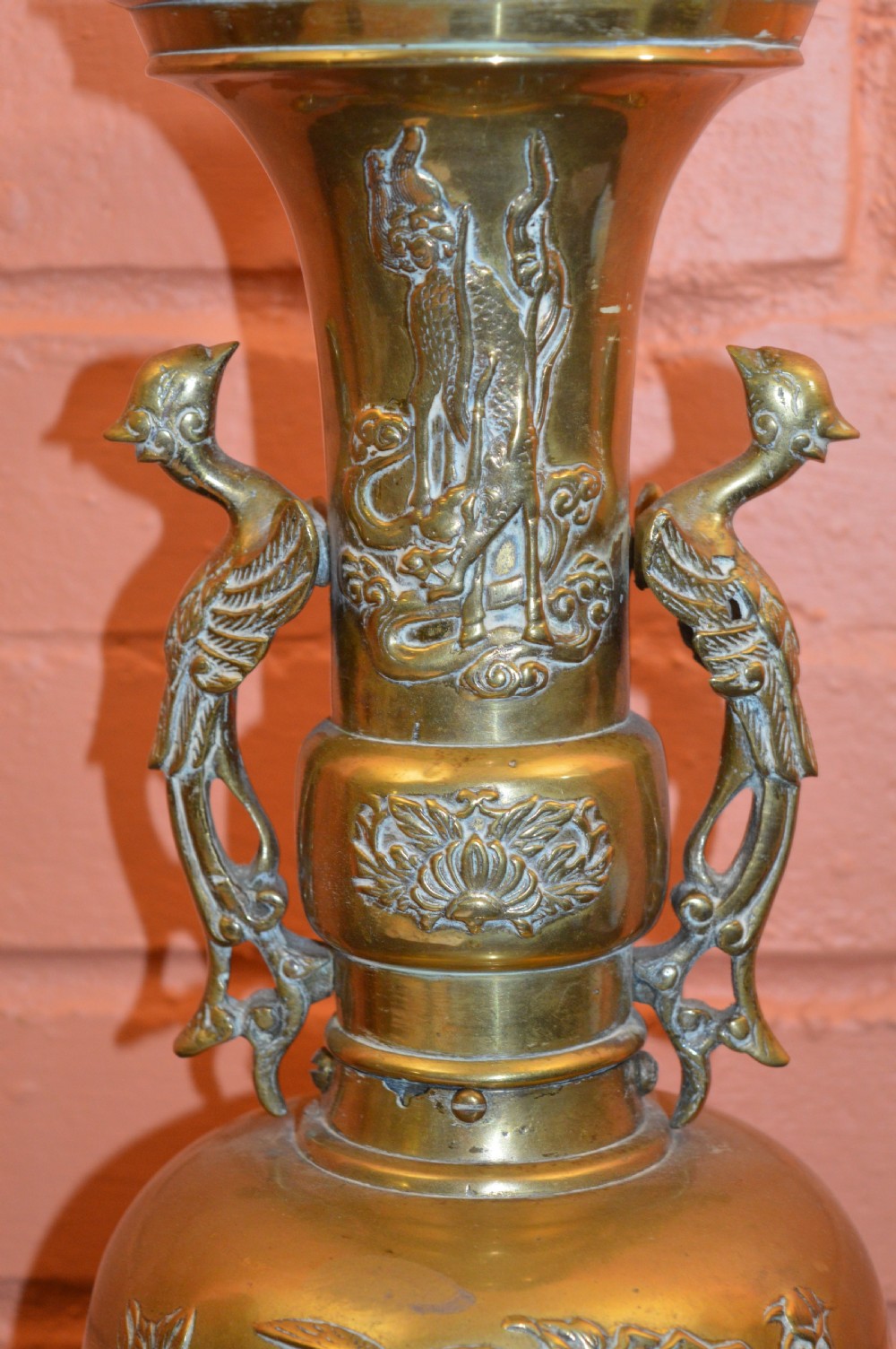 A nineteenth-century Chinese bronze vase featuring bird-shaped handles and intricate relief-carved floral motifs on a flared baluster body. View II