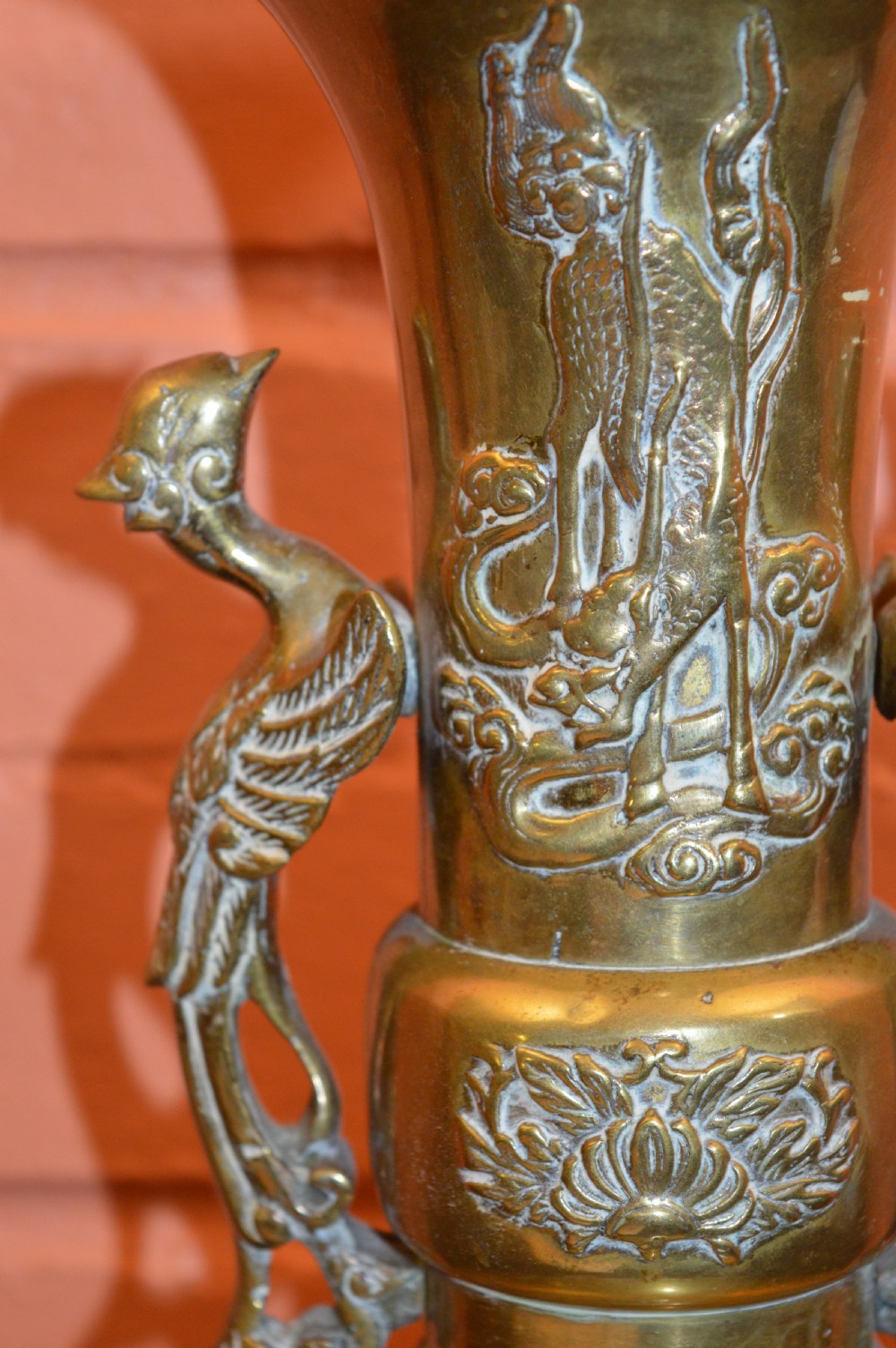 A nineteenth-century Chinese bronze vase featuring bird-shaped handles and intricate relief-carved floral motifs on a flared baluster body. View III