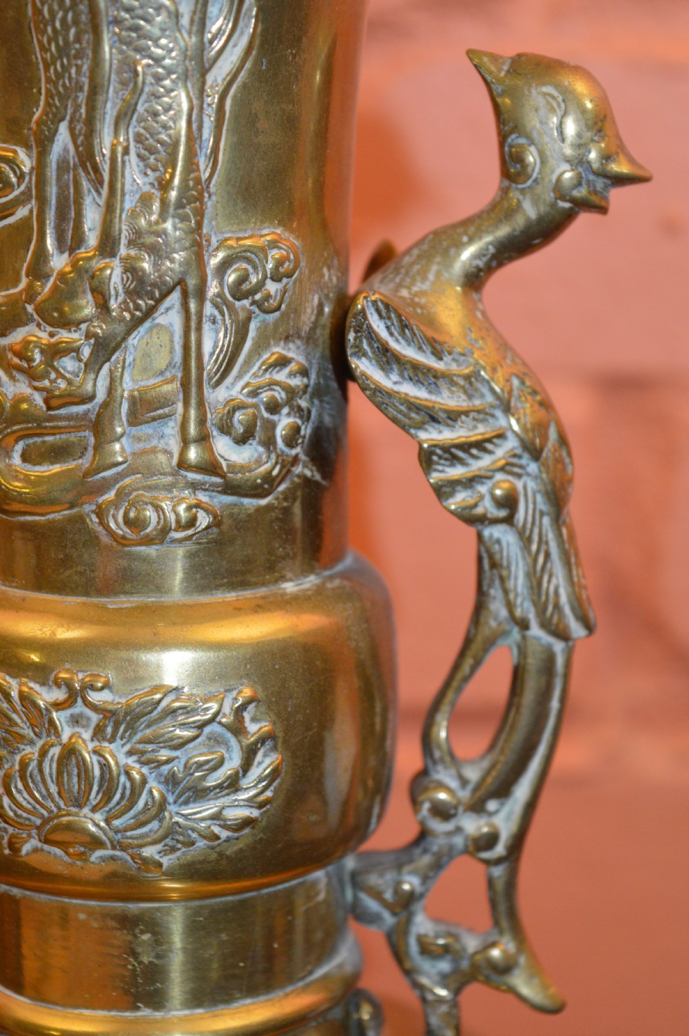 A nineteenth-century Chinese bronze vase featuring bird-shaped handles and intricate relief-carved floral motifs on a flared baluster body. View IV