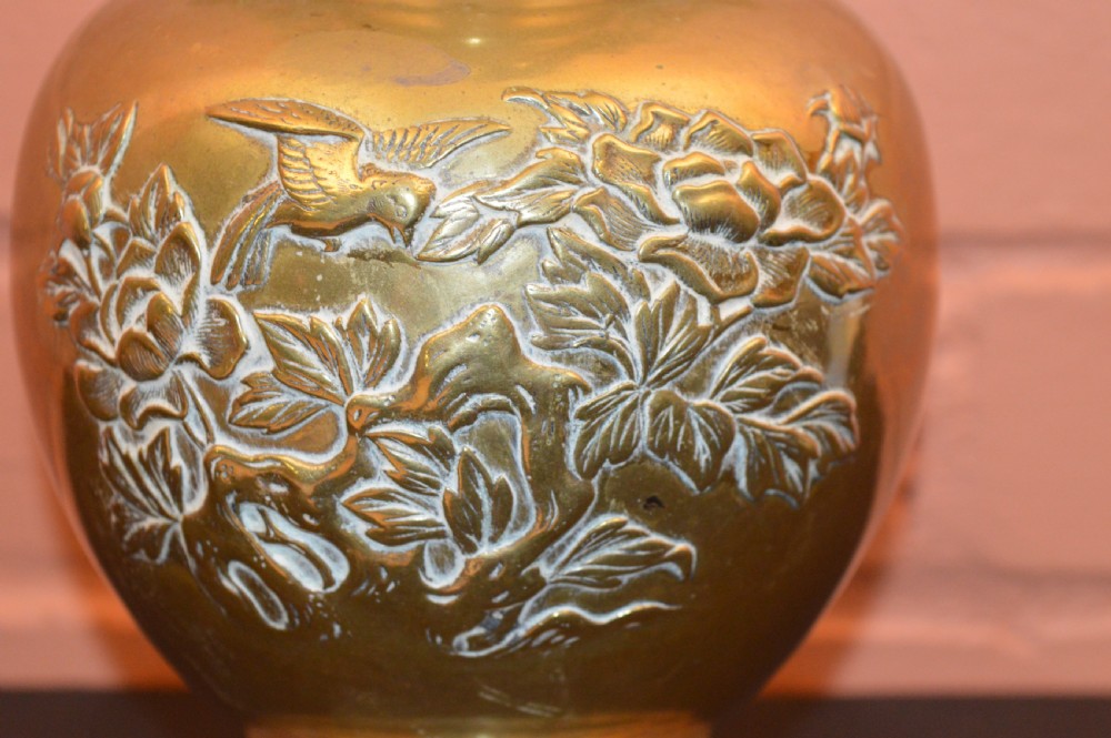 A nineteenth-century Chinese bronze vase featuring bird-shaped handles and intricate relief-carved floral motifs on a flared baluster body. View V
