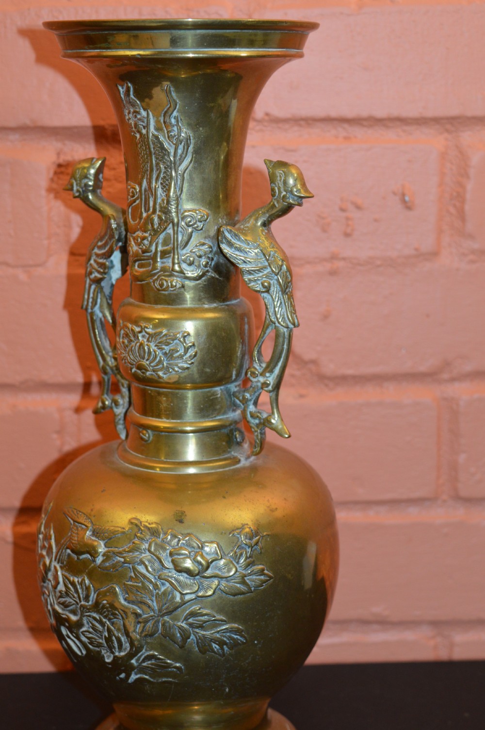 A nineteenth-century Chinese bronze vase featuring bird-shaped handles and intricate relief-carved floral motifs on a flared baluster body. View VI