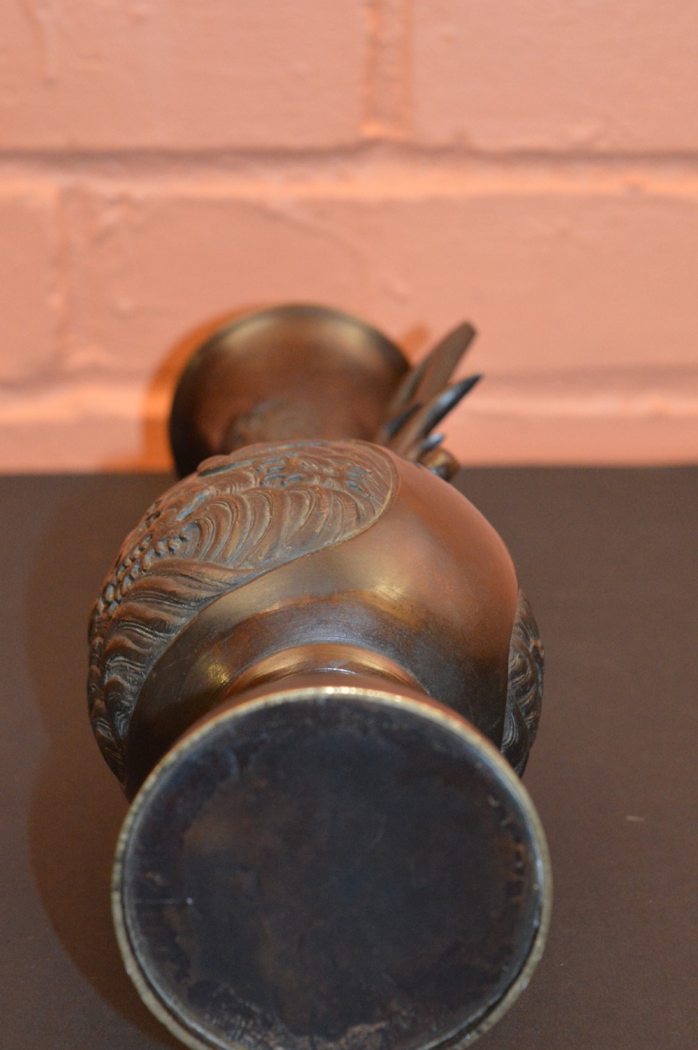 A dark brown patinated Japanese bronze vase featuring stylised handles, a flared neck, and raised relief carvings of birds over waves. View IV