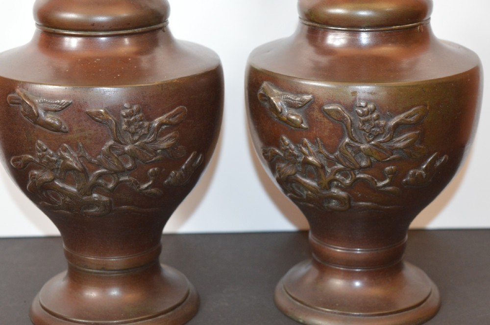 A pair of patinated dark brown Chinese bronze altar vases featuring sculpted dragon handles and low-relief carvings of birds and floral motifs. View III