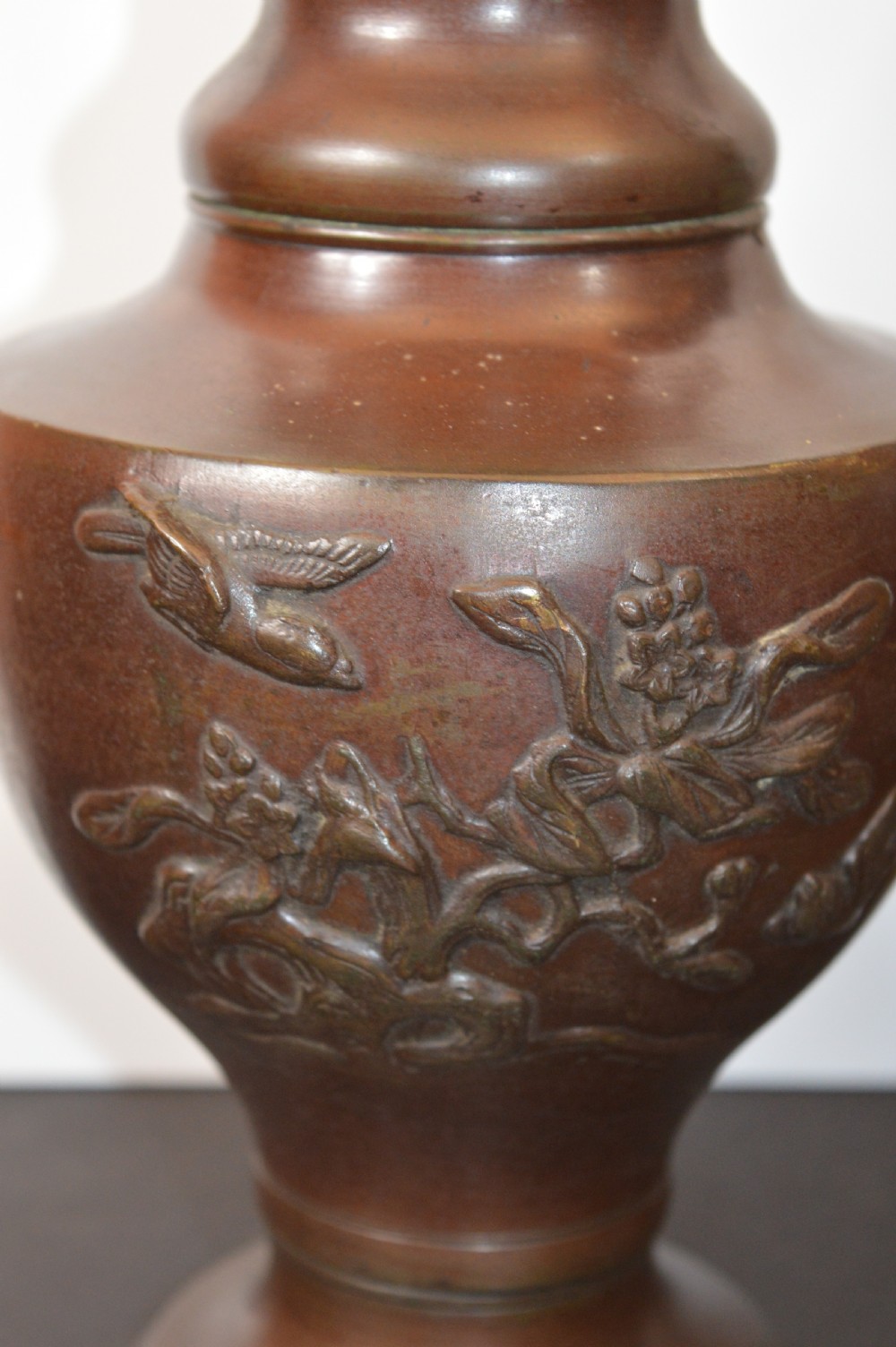 A pair of patinated dark brown Chinese bronze altar vases featuring sculpted dragon handles and low-relief carvings of birds and floral motifs. View V