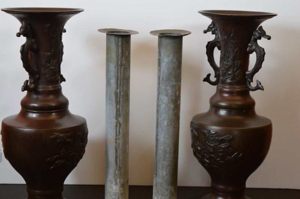 A pair of patinated dark brown Chinese bronze altar vases featuring sculpted dragon handles and low-relief carvings of birds and floral motifs. View IX