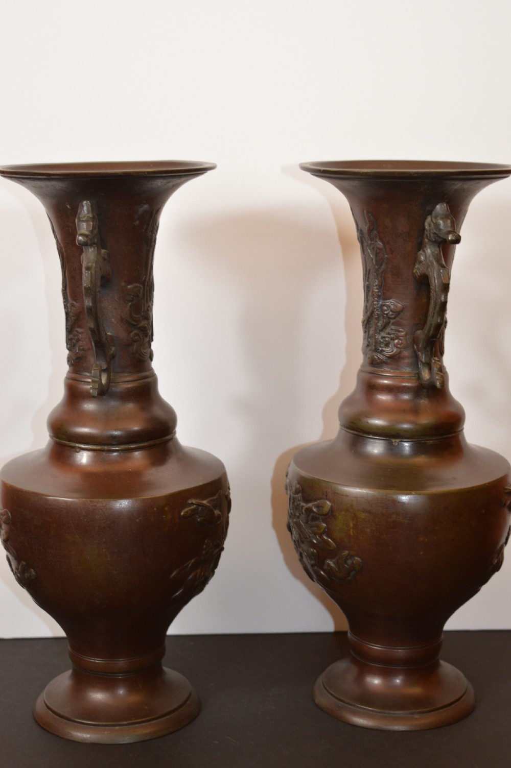 A pair of patinated dark brown Chinese bronze altar vases featuring sculpted dragon handles and low-relief carvings of birds and floral motifs. View XIII