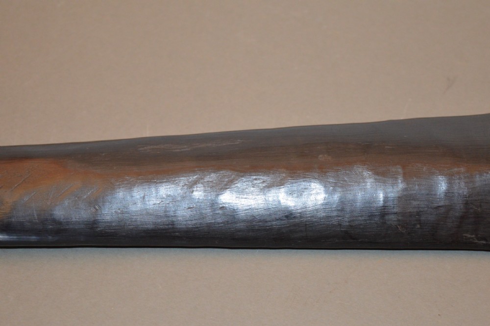 A late 19th-century Polynesian hardwood paddle club featuring a carved central ridge running along the length of its elongated blade section. View III