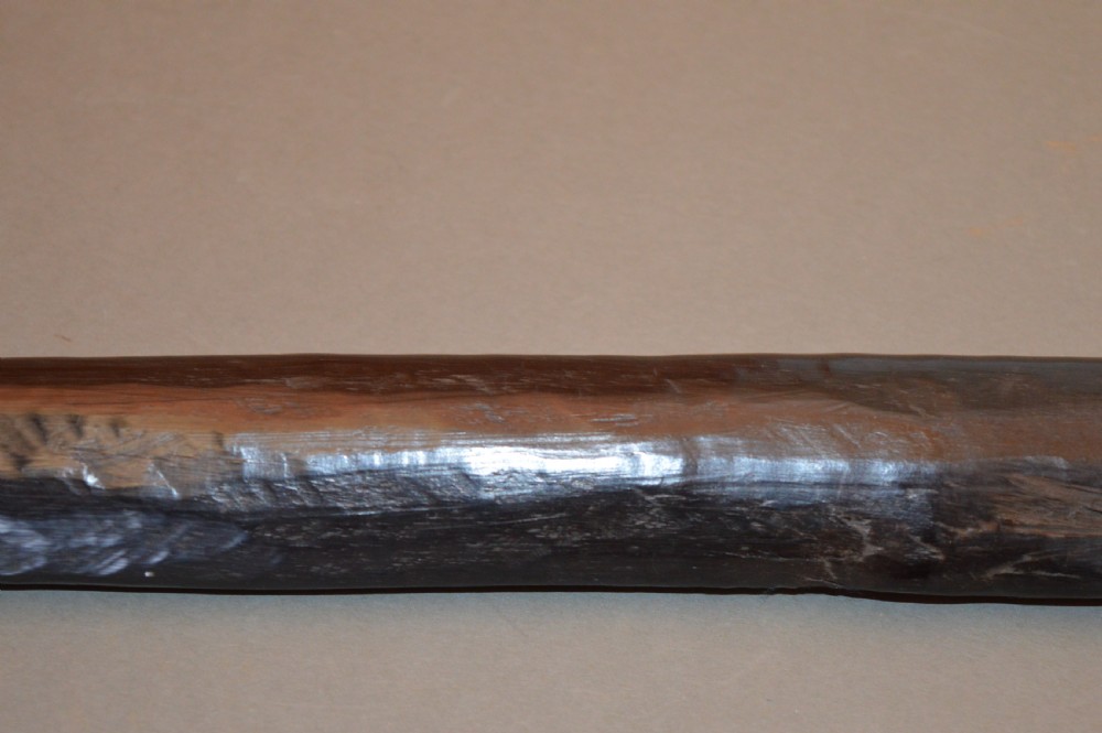 A late 19th-century Polynesian hardwood paddle club featuring a carved central ridge running along the length of its elongated blade section. View IV