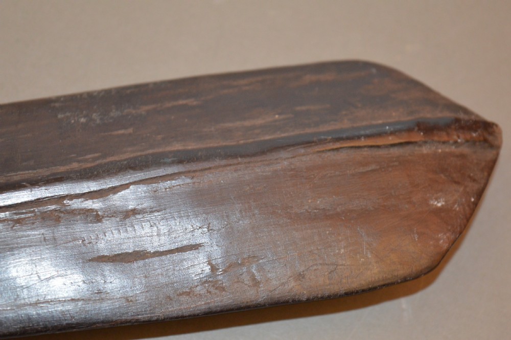 A late 19th-century Polynesian hardwood paddle club featuring a carved central ridge running along the length of its elongated blade section. View VIII