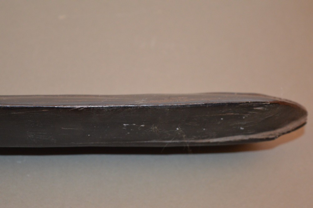 A late 19th-century Polynesian hardwood paddle club featuring a carved central ridge running along the length of its elongated blade section. View IX