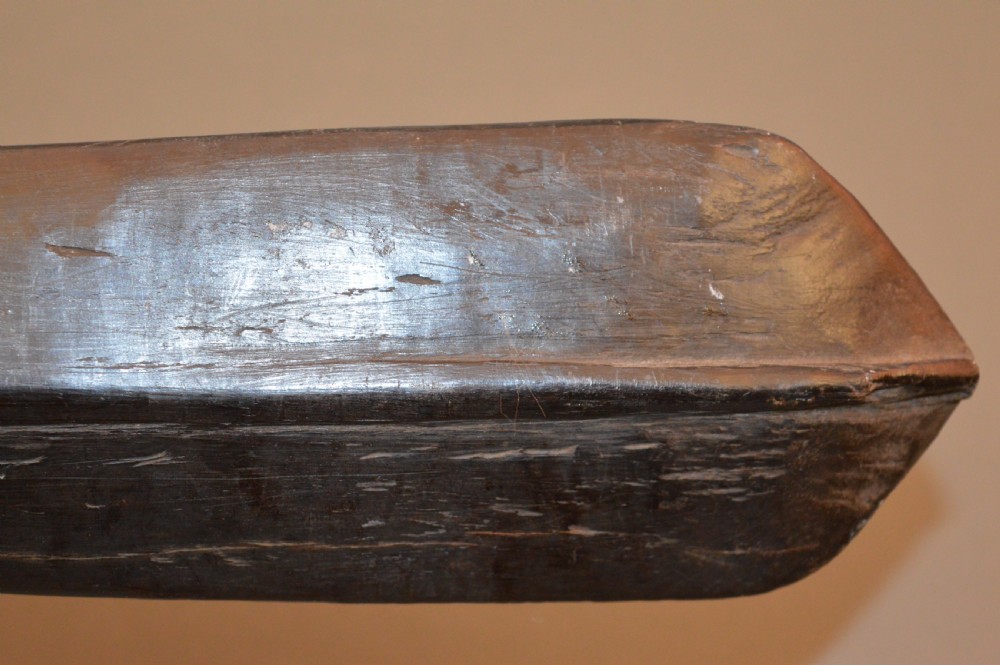 A late 19th-century Polynesian hardwood paddle club featuring a carved central ridge running along the length of its elongated blade section. View X