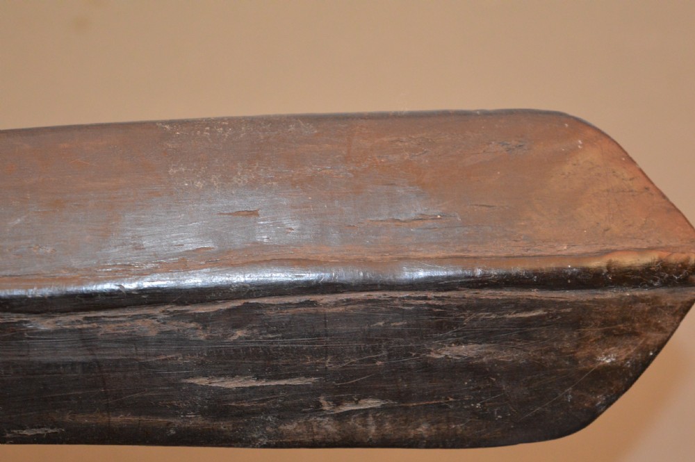 A late 19th-century Polynesian hardwood paddle club featuring a carved central ridge running along the length of its elongated blade section. View XI