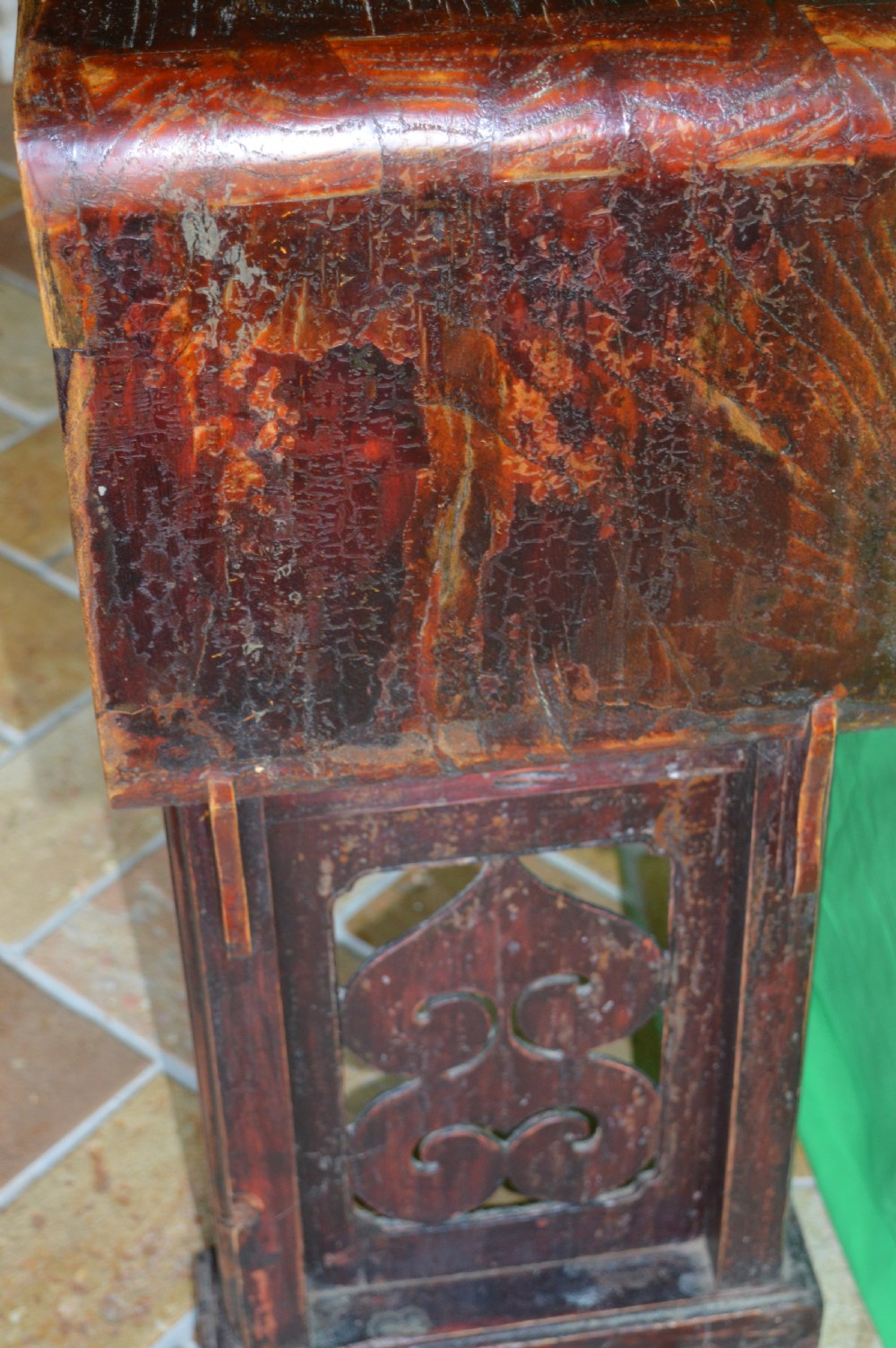 A long dark hardwood Tibetan altar table featuring a flat rectangular top supported by upright legs with prominent carved scroll terminals. View VIII