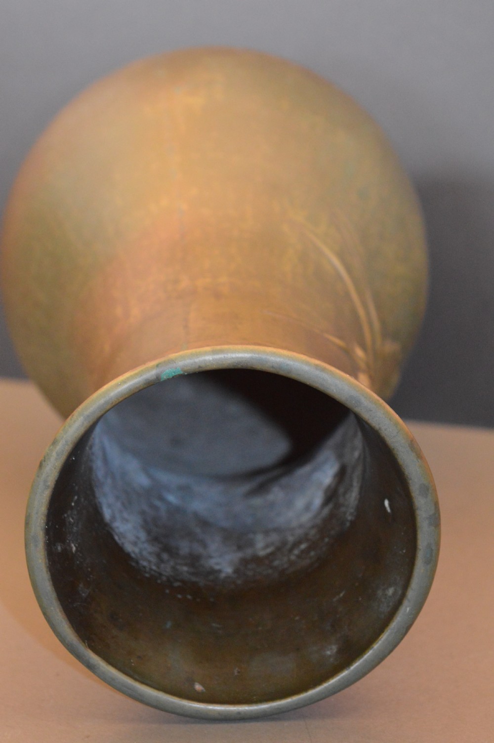 A tall baluster-shaped bronze vase featuring a high-relief carved dragon emerging from swirling waves and cloud motifs. View IX